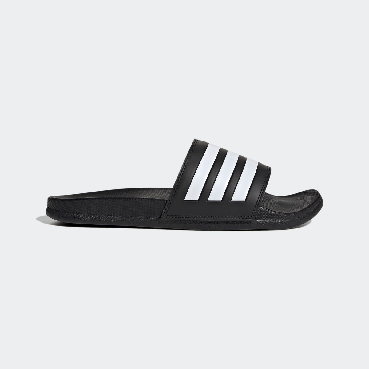 Black Adidas slide sandal on a light gray background