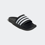 adidas Black slide sandal with white stripes on a light gray background