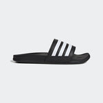 Black Adidas slide sandal on a light gray background