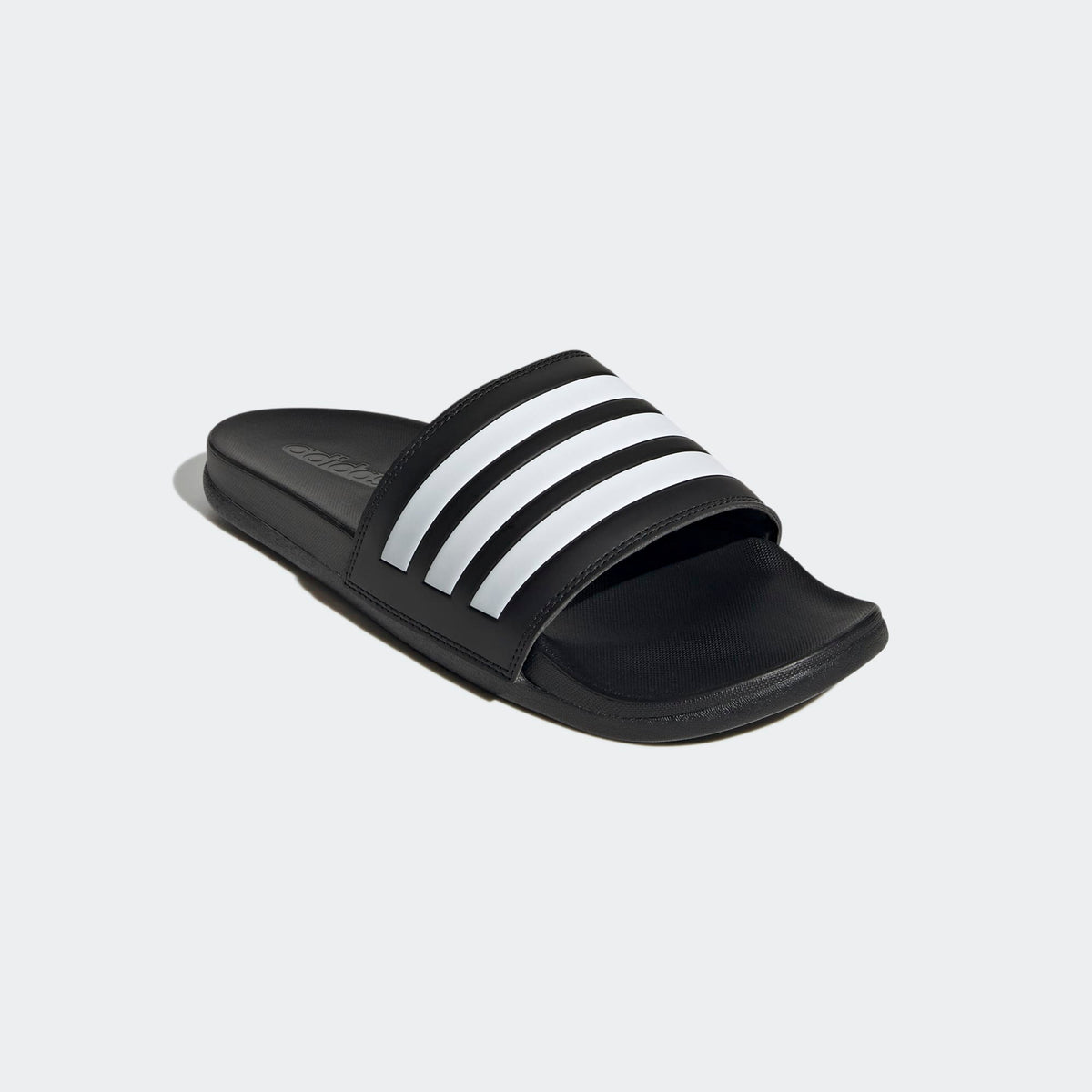 adidas Black slide sandal with white stripes on a light gray background