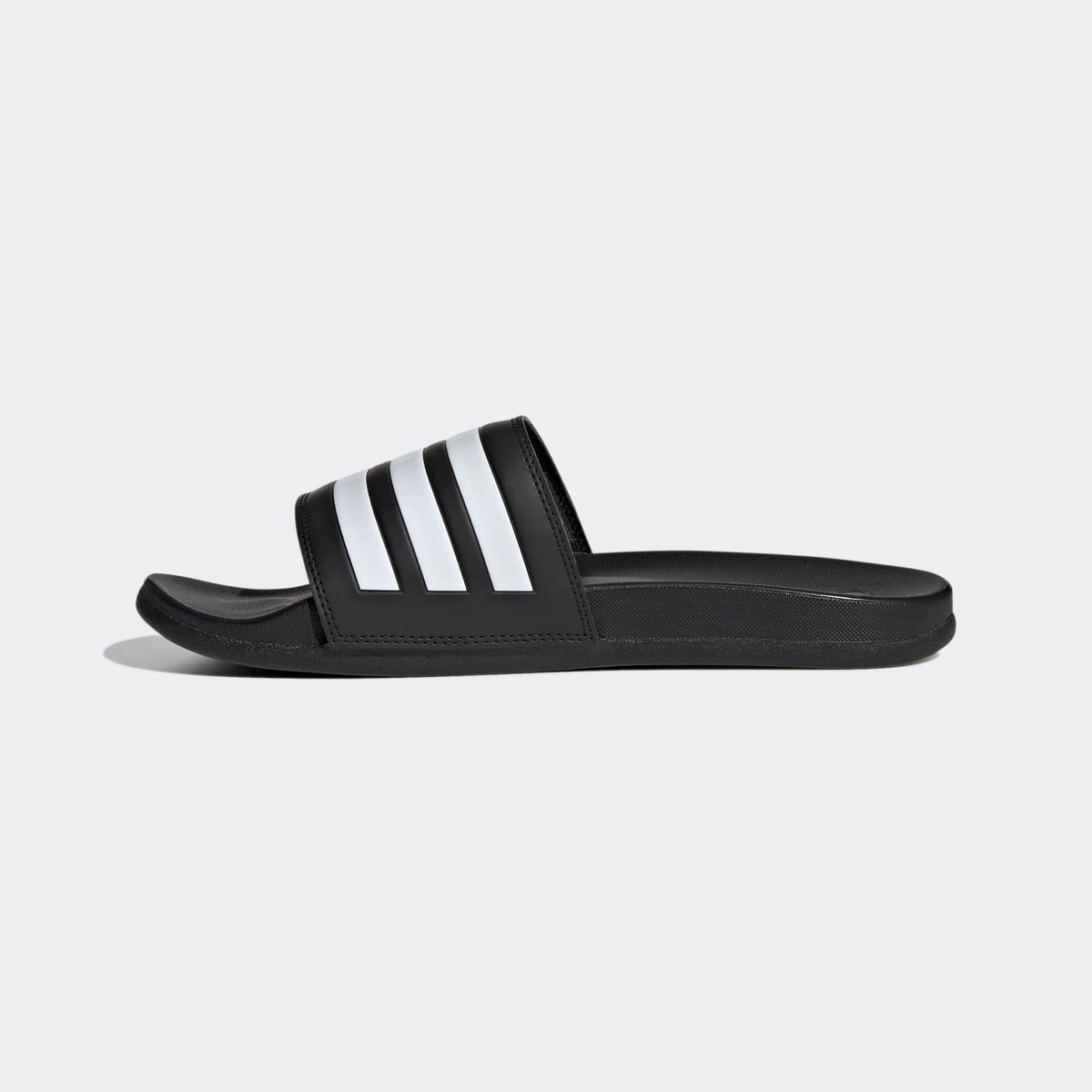 Black slide sandal with white stripes on a light gray background