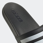 Black Adidas sandal with logo on a light gray background